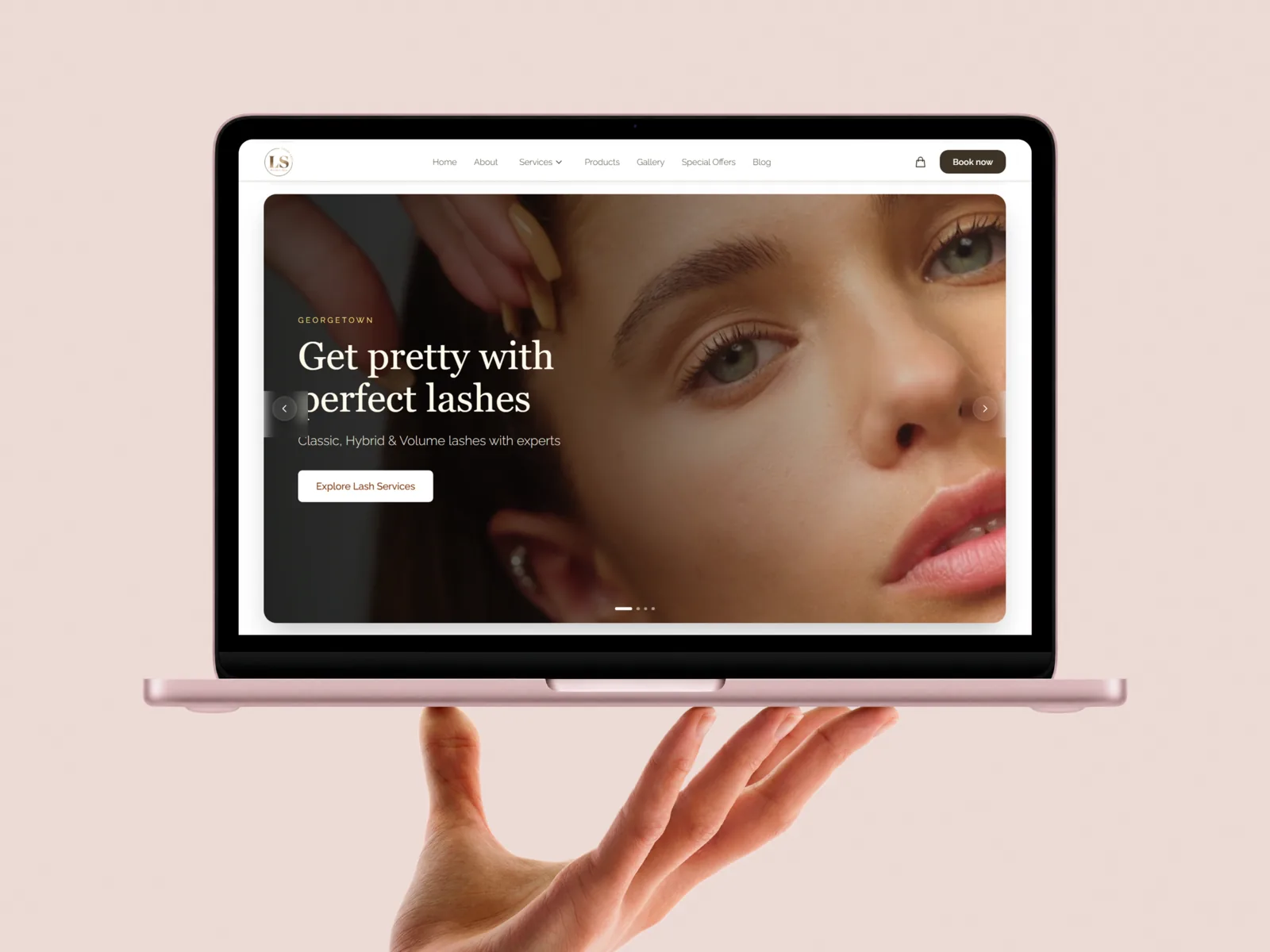 Lashiskin website displayed on a laptop held by a hand